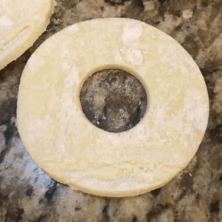 Preheating the air fryer to 400°F to achieve golden, puffed donuts.