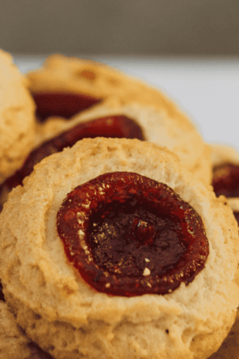 Golden, soft thumbprint cookies fresh from the air fryer, filled with fruity jam centers.