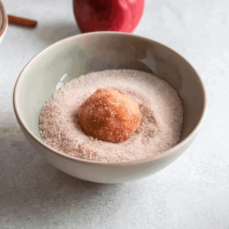 Roll the donuts in the cinnamon sugar mixture.