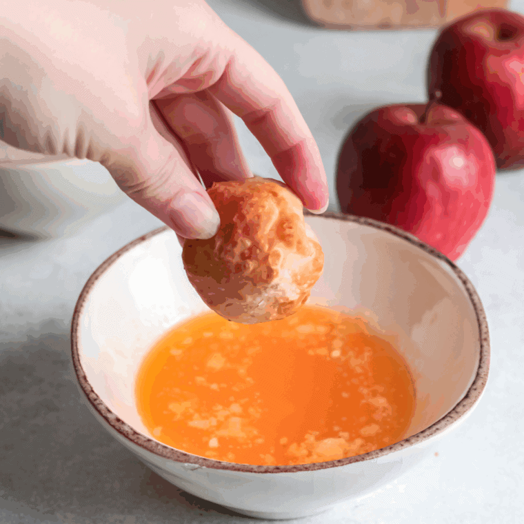Dip the munchkins in the melted butter.