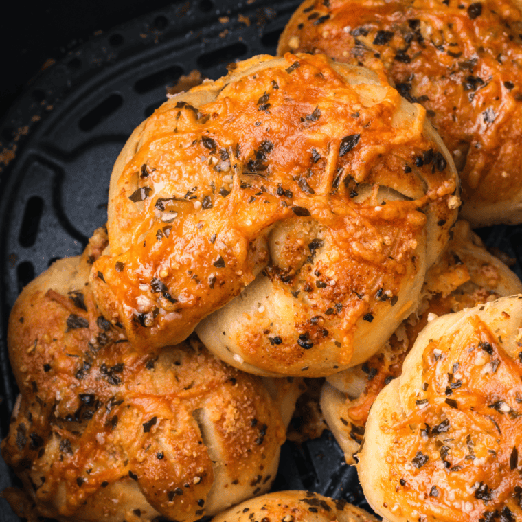 Golden-brown Trader Joe's Air Fryer Garlic Cheddar Knots with melted cheese and garlic butter glaze.