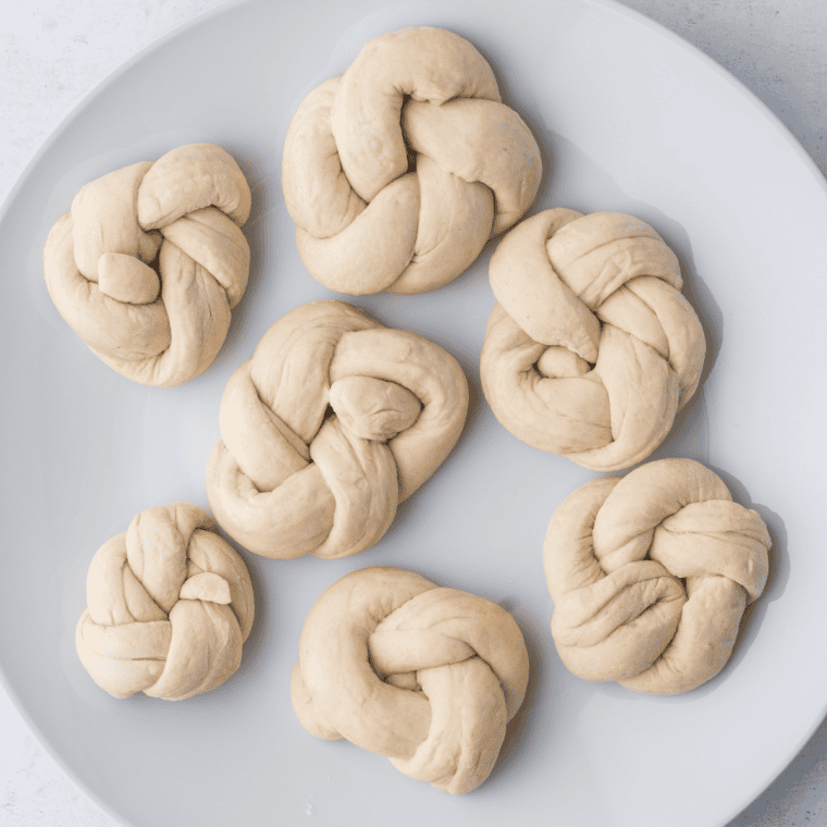 A plate of uncooked Trader Joe’s Air Fryer Garlic Cheddar Knots ready to be cooked."