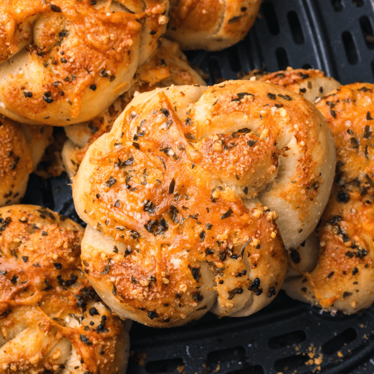 Golden, crispy Trader Joe’s Air Fryer Garlic Cheddar Knots topped with melted cheese and garlic butter.