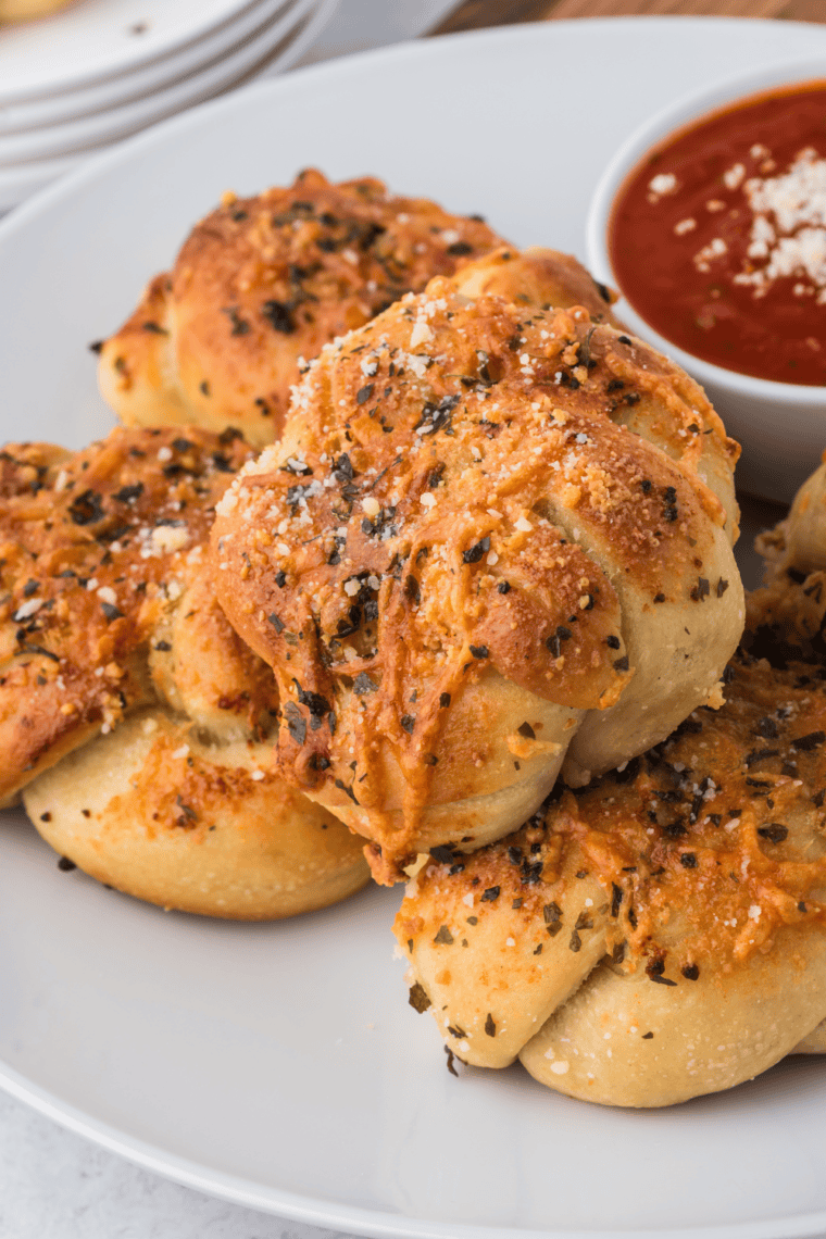 Golden, crispy Trader Joe’s Air Fryer Garlic Cheddar Knots topped with garlic butter and melted cheese.