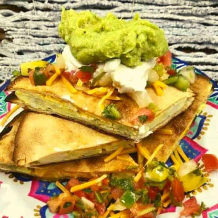 Air fryer breakfast quesadilla with scrambled eggs, cheese, and tortillas.