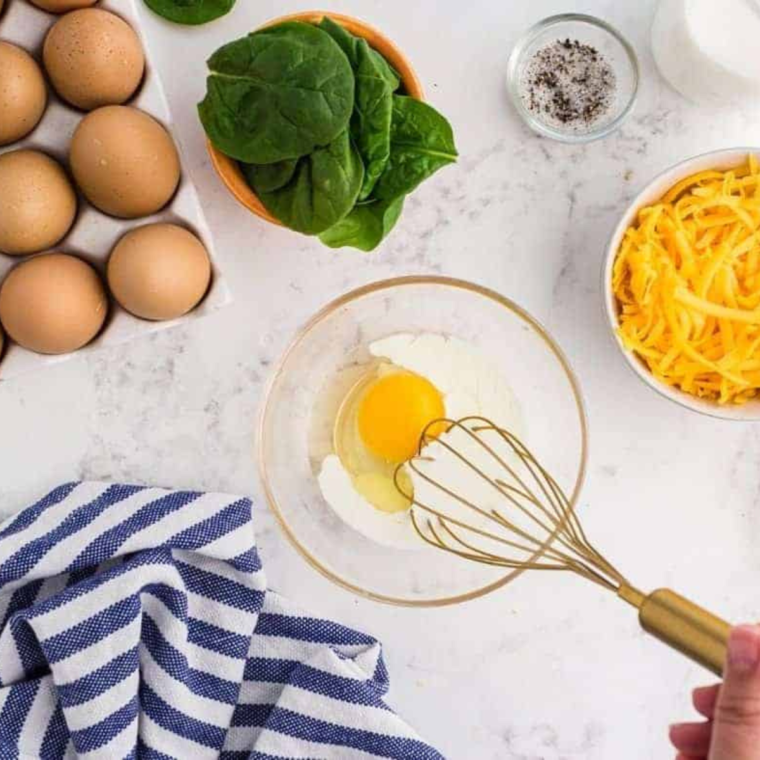 Crack eggs into a bowl, adding milk, salt, and pepper.