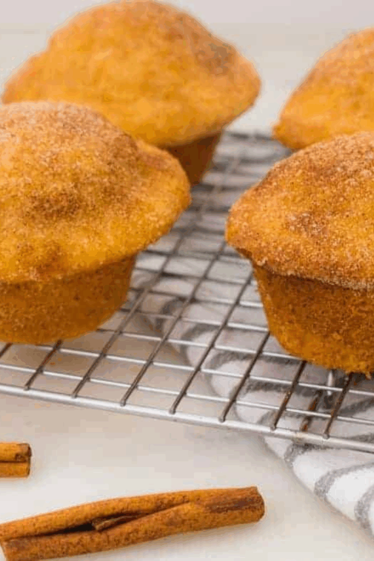Freshly baked air fryer cinnamon sugar muffins with soft centers and crunchy cinnamon sugar topping.