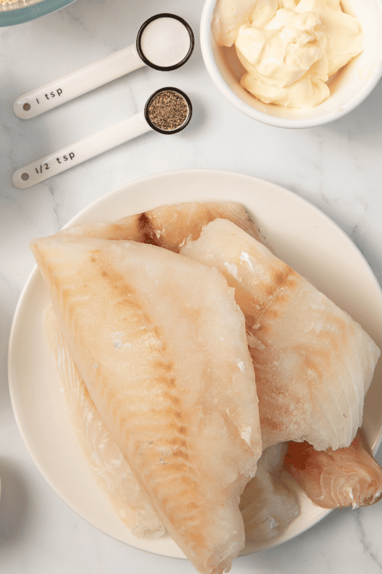 Ingredients needed for Air Fryer Frozen Haddock Crispy in Under 15 Minutes on kitchen table.
