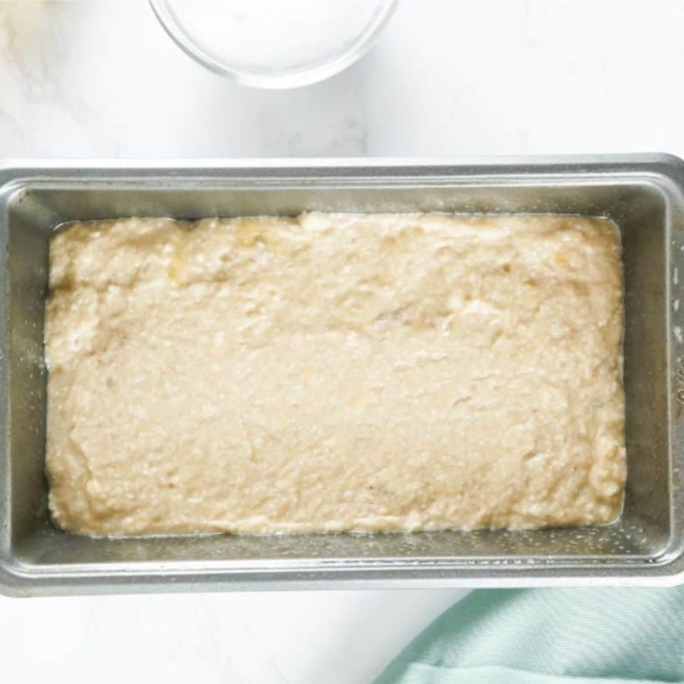 Raspberry lemon batter divided into three greased mini loaf pans