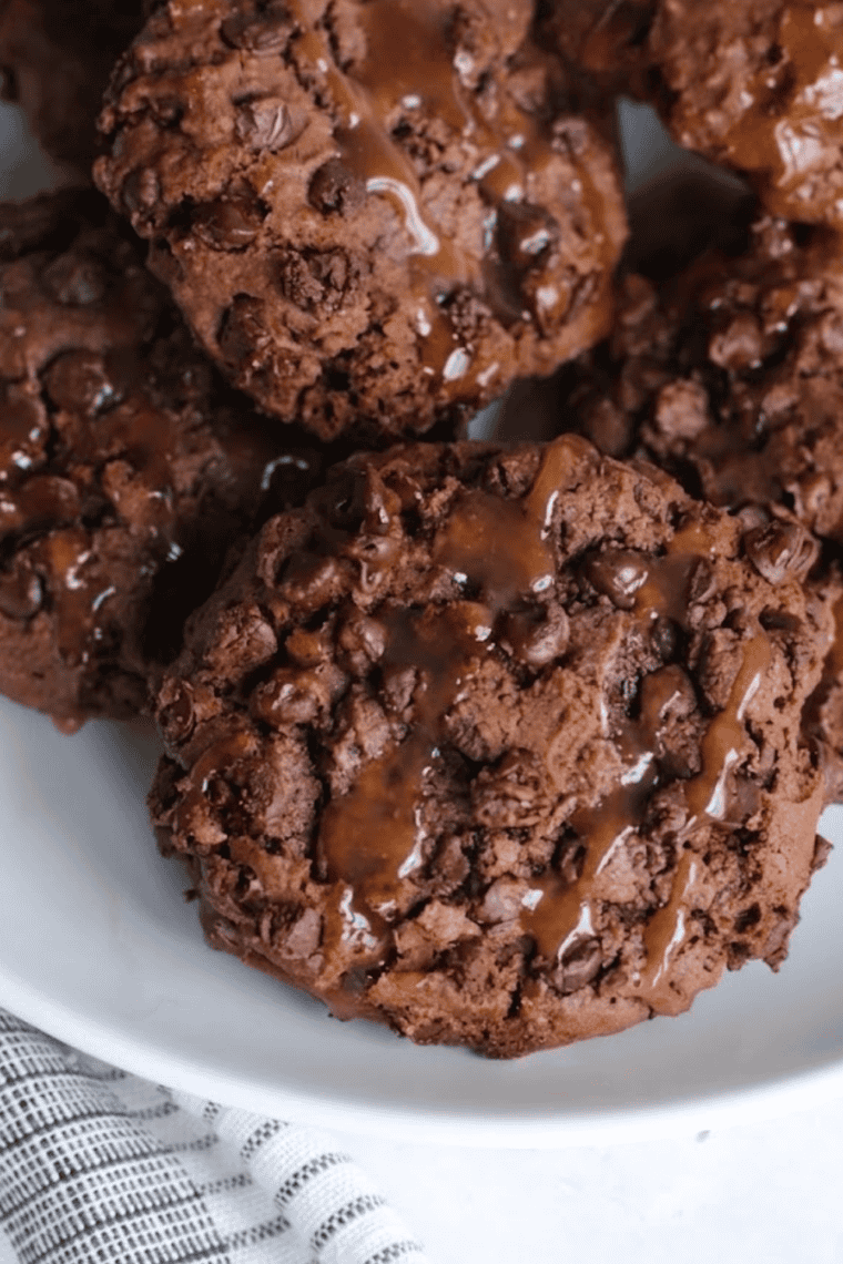 Plate of soft, chewy Air Fryer Salted Caramel Chocolate Chip Cookies with gooey caramel and chocolate chunks.