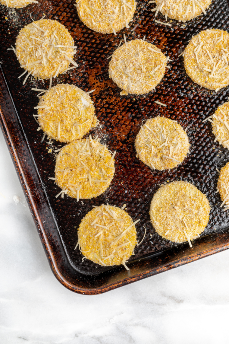 Air fryer summer squash on a plate topped with fresh parsley, lemon, and grated Parmesan