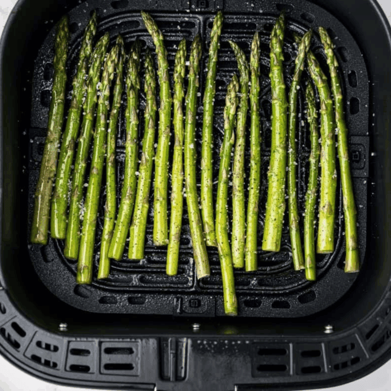 Preparing Easy Chili&rsquo;s Asparagus Recipe in the air fryer basket.