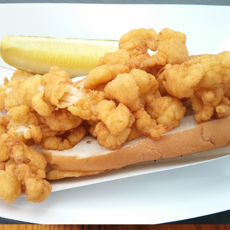Fried clam basket with French fries and a lemon wedge for a shack-style lunch