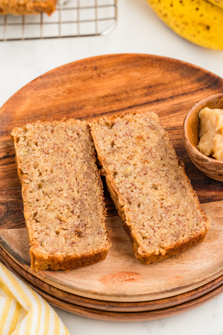 Overhead shot of banana nut bread baked in an air fryer loaf pan with a golden crust and walnuts sprinkled on top.