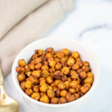 A bowl of crispy air fryer taco seasoned chickpeas dusted with chili powder and cumin