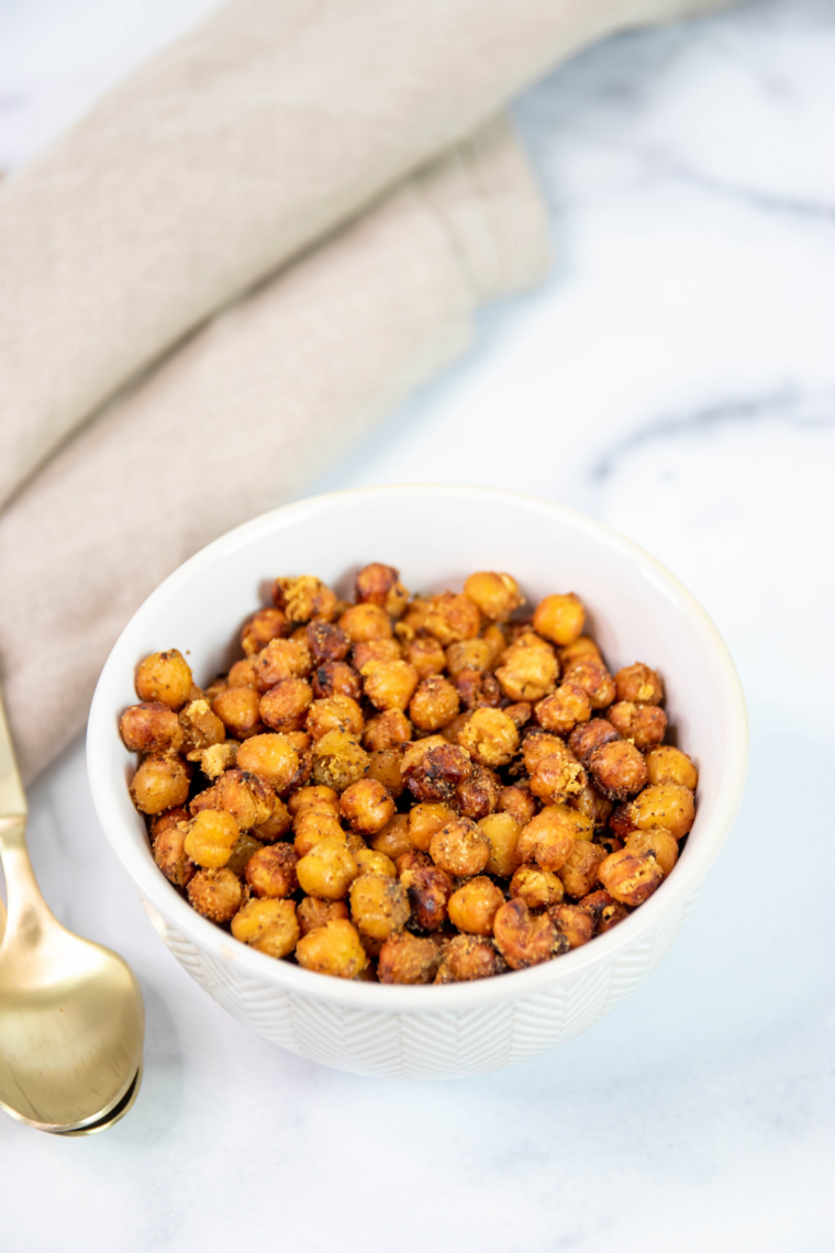 Close-up of golden air fryer taco chickpeas in a white bowl, crispy and freshly seasoned