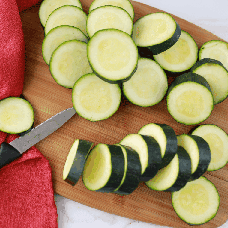 Sliced zucchini on the cutting board.