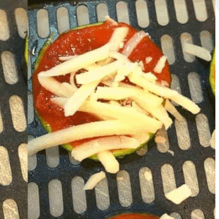 Sprinkle mozzarella cheese over the pizza sauce.