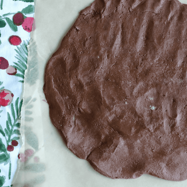 Chocolate chips being folded gently into the cookie dough.