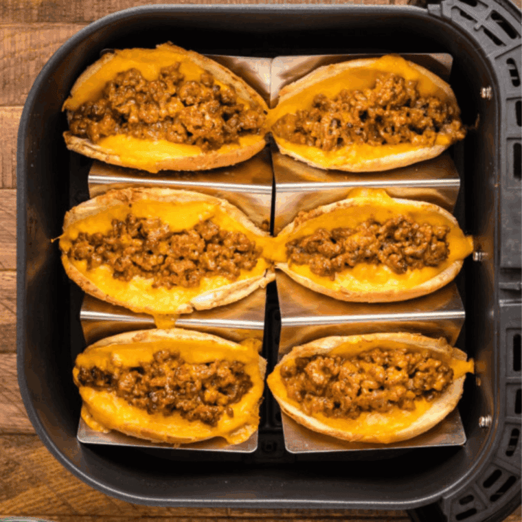 Air fryer cooked ground beef tacos with seasoned beef, fresh toppings, and crispy taco shells.