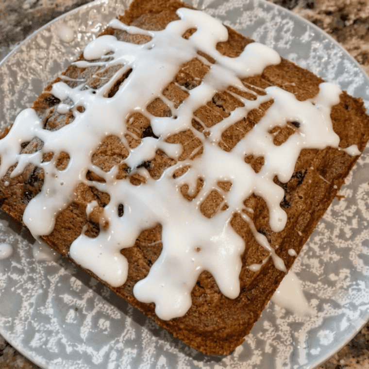 Close-up of a single apple butter bar showing the soft spiced crumb inside
