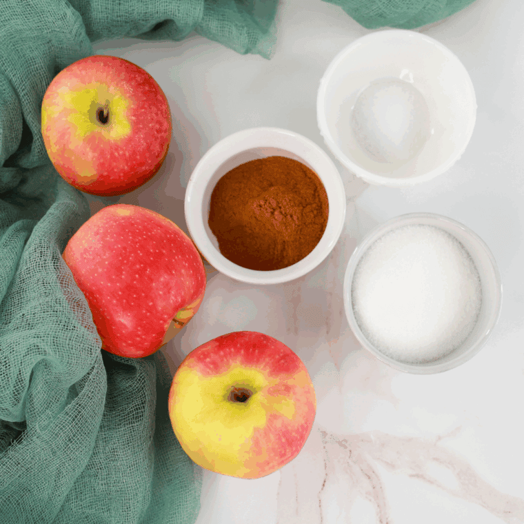 Ingredients needed for Air Fryer Apple Pie Biscuit Casserole on kitchen table.