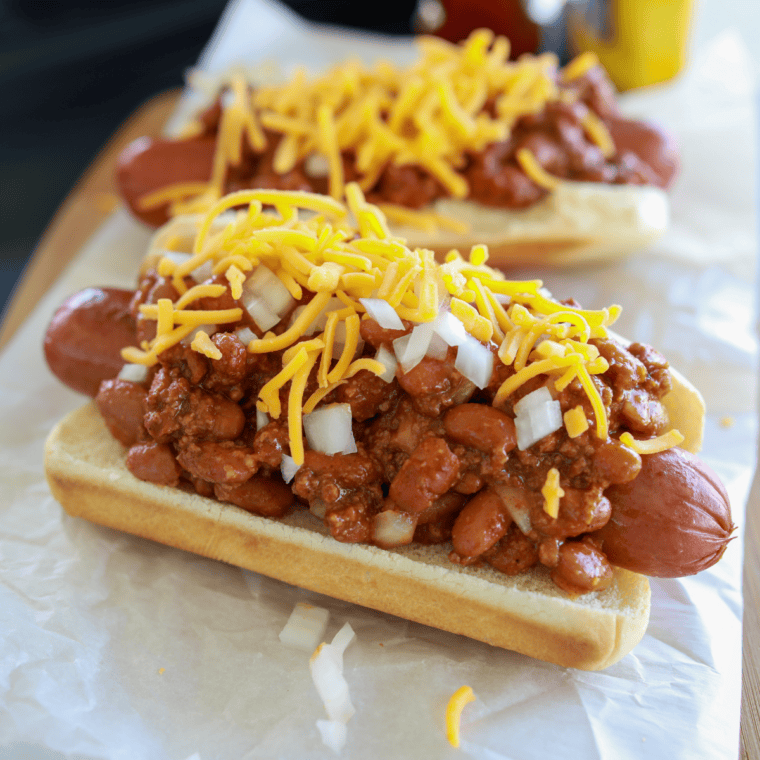 Golden crispy air fryer bacon wrapped hot dogs with bacon wrapped tightly around juicy hot dogs, cooked until crunchy and browned.