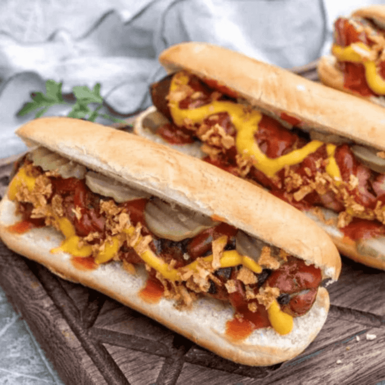 Crispy air fryer bacon wrapped hot dogs cooked golden brown with bacon wrapped around juicy hot dogs.