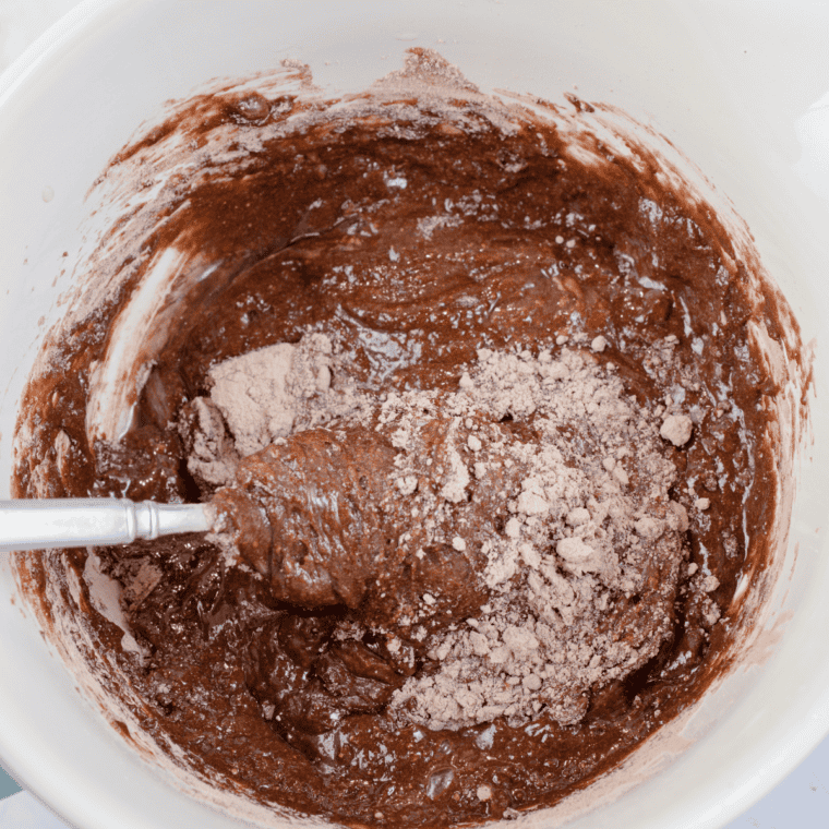 Whisking boxed brownie mix into a smooth batter for mini brownies