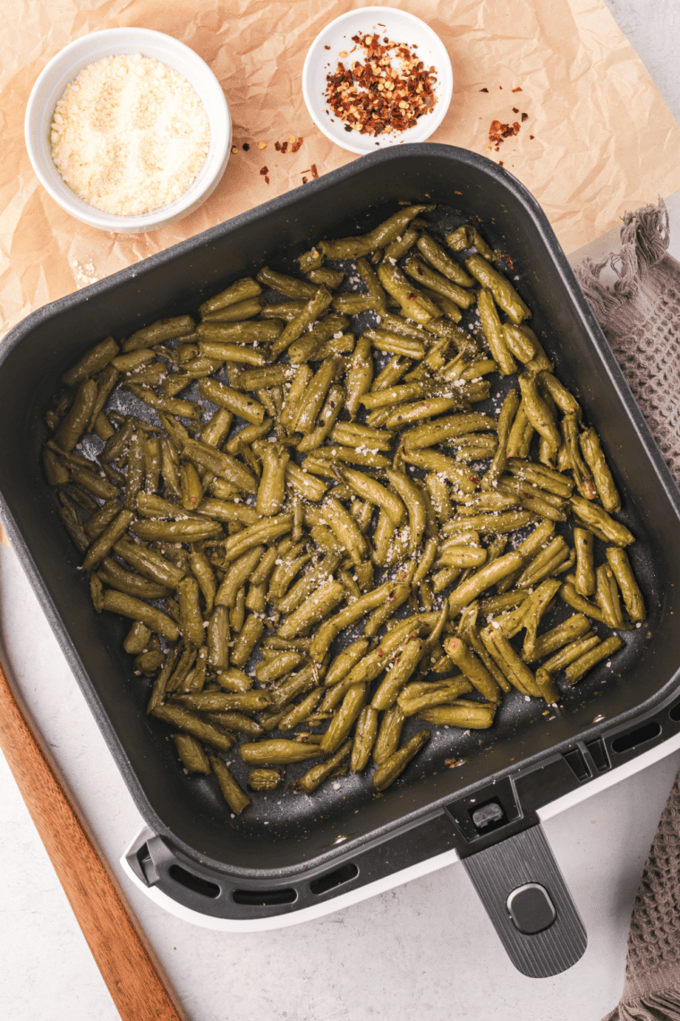 Plate of crispy, golden brown air fryer canned green beans served as a delicious side dish.