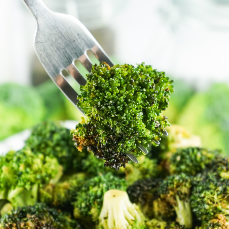 Crispy Air Fryer Frozen Broccoli served in a bowl, garnished with seasoning.