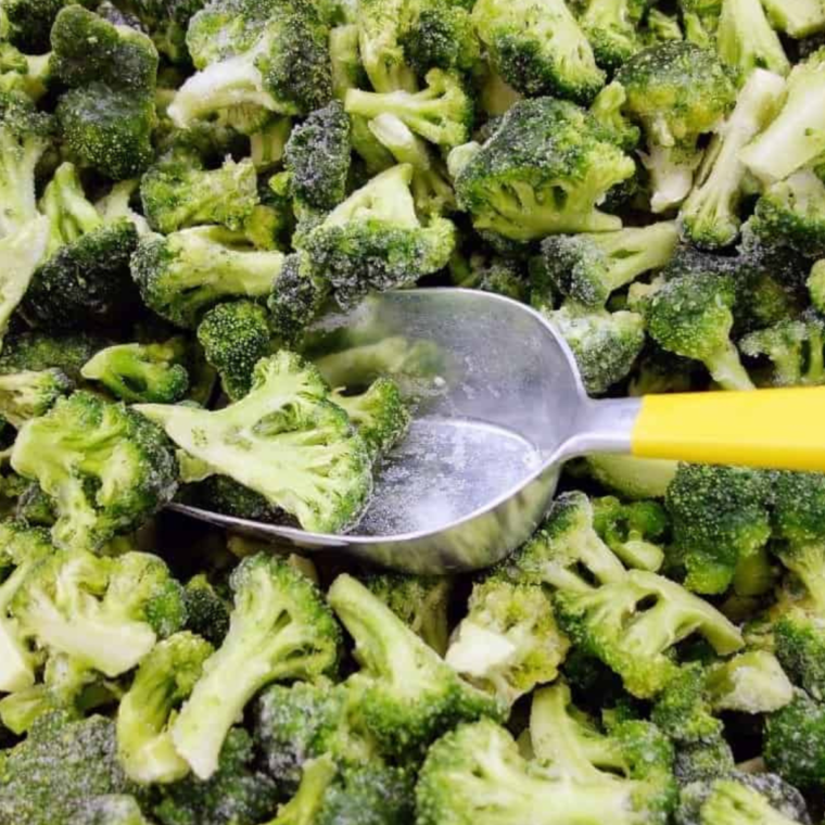 Ingredients needed for Crispiest Air Fryer Frozen Broccoli in large bowl.