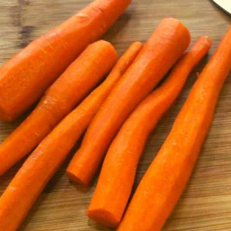 Slicing fresh carrots for air fryer garlic roasted carrots