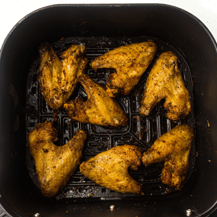 Cooked Air Fryer Honey Mustard Chicken Wings in the air fryer basket.