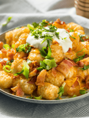 Loaded Air Fryer Tater Tots -- Get ready to elevate your snack game with our Loaded Air Fryer Tater Tots! Imagine your favorite crispy, golden tater tots coming hot out of the air fryer, then loaded with all the mouth-watering toppings that scream indulgence. We're talking melted cheese, crispy bacon bits, a sour cream dollop, and fresh green onions.