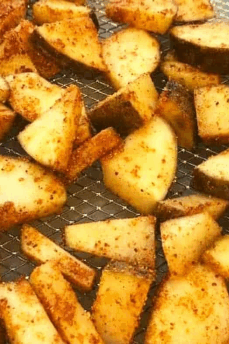 Golden air fryer red and Russet potato slices coated in maple BBQ seasoning, crispy outside, tender inside, served on a plate.