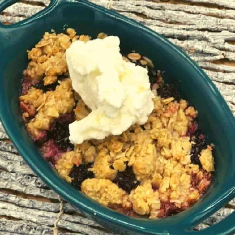 Air Fryer Oatmeal Cake in a blue bowl, with ice cream on top.