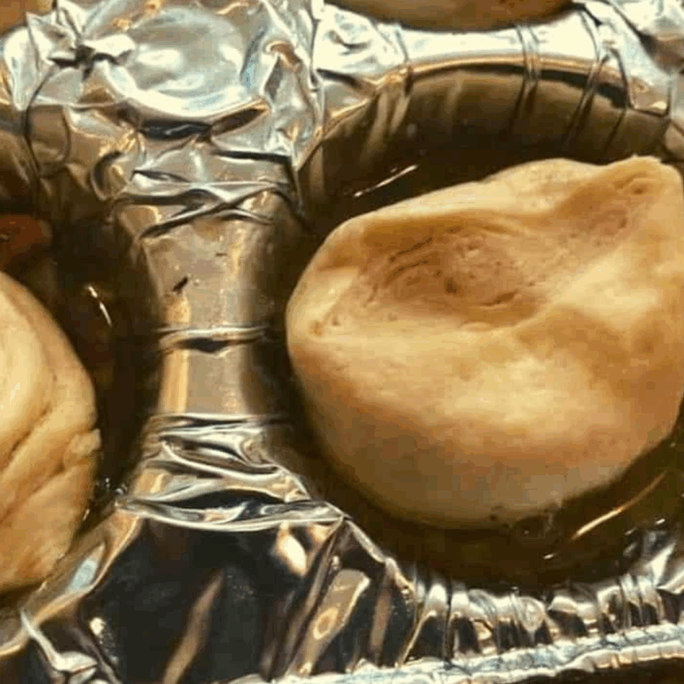 Add the dough on top of the topping.