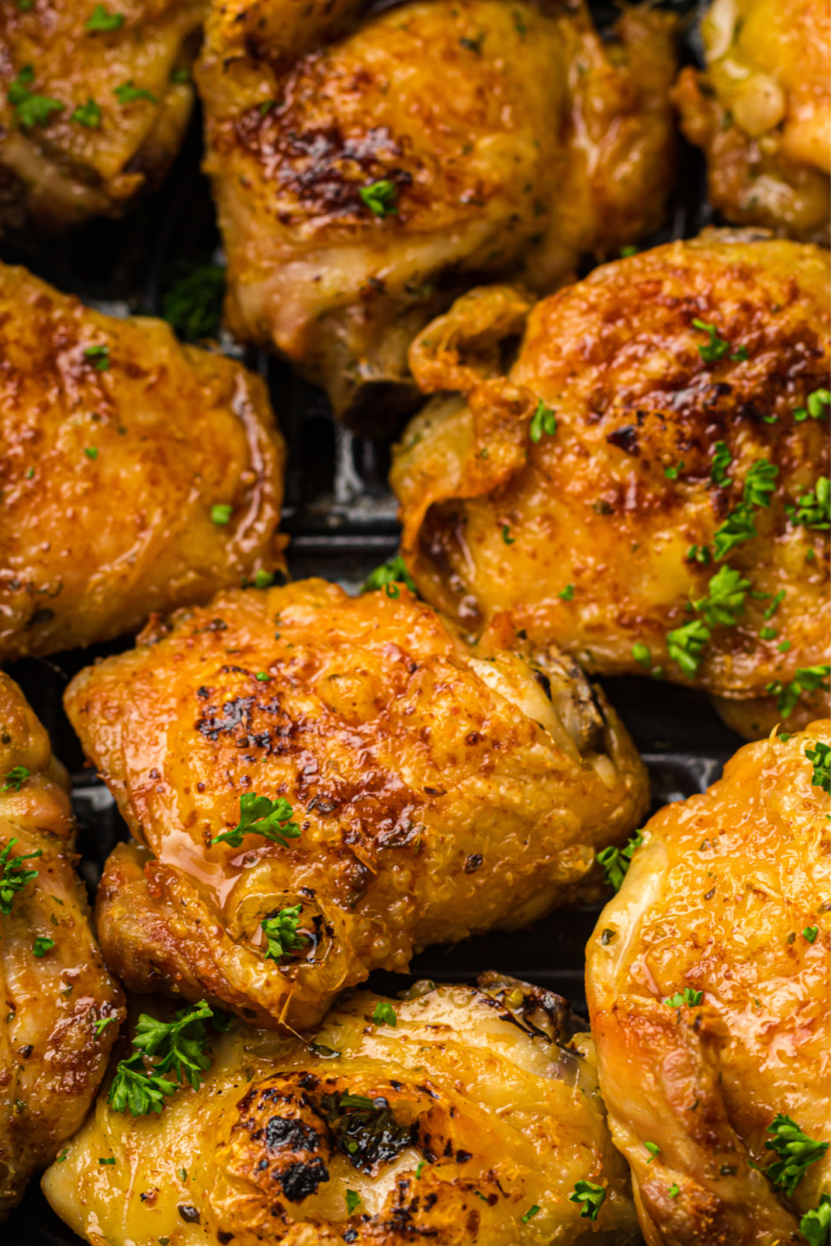 Instant-read thermometer reading 178&deg;F inserted into a bone-in pesto chicken thigh
