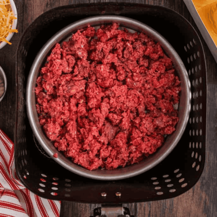 Cooking ground pork in a baking pan.