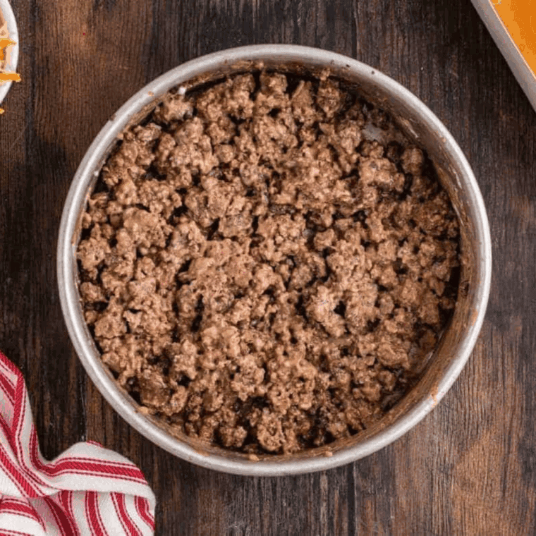 Cooked ground pork in the air fryer safe pan.