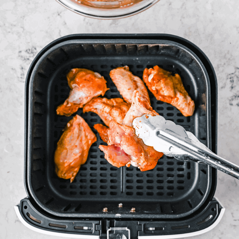 Drizzle chicken wings with olive oil, season with salt, garlic powder, onion powder, black pepper, and thyme, then toss to coat.
