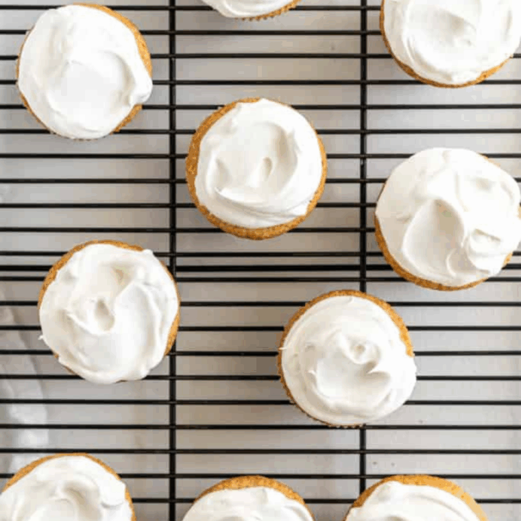 Air fryer vanilla cupcakes in paper liners, golden and fluffy, ready to serve or frost.
