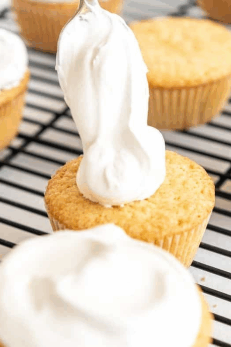 Air fryer vanilla cupcakes in paper liners, golden and fluffy, ready for frosting and serving.