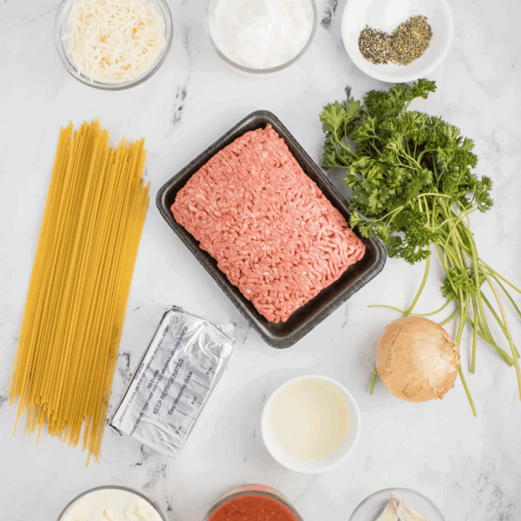 Ingredients needed for Carrabba’s Spaghetti Recipe on kitchen table.
