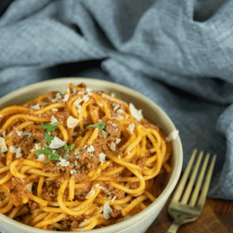 Plate of Carrabba’s Spaghetti topped with hearty meat sauce and fresh parsley..