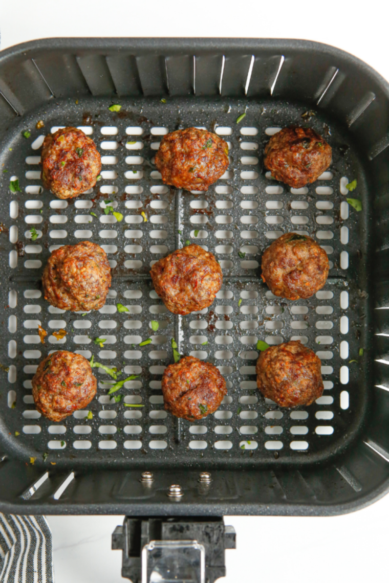 Air fryer BBQ meatballs coated in sticky caramelized barbecue sauce served hot and juicy in a bowl.