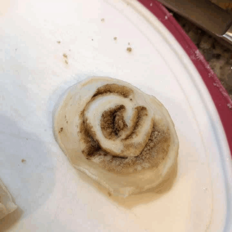 Using a sharp knife cut Easy Air Fryer Cinnamon Rolls from Frozen Bread Dough.