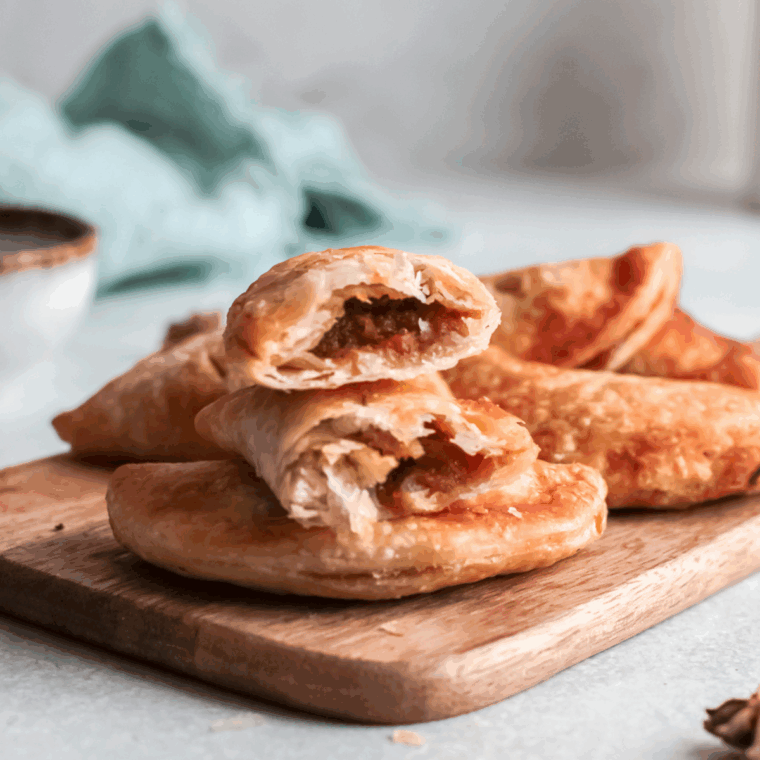 Golden, flaky pumpkin hand pies made in the air fryer, filled with creamy spiced pumpkin filling and dusted with cinnamon sugar.