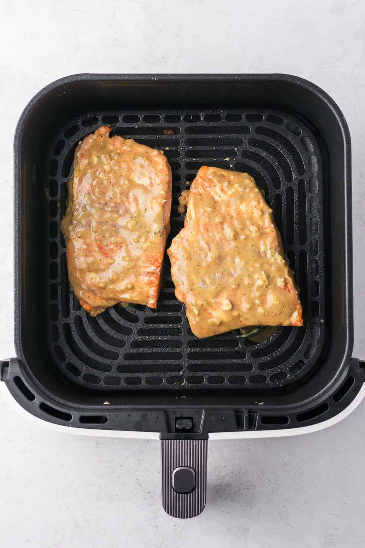 Cooking salmon covered in sauce, in the air fryer